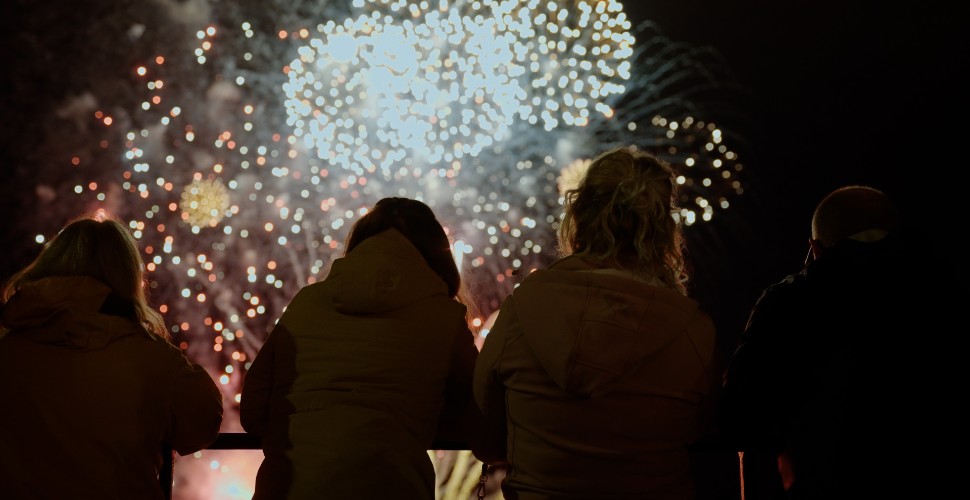 People stood watching the British Firework Championships in Plymouth